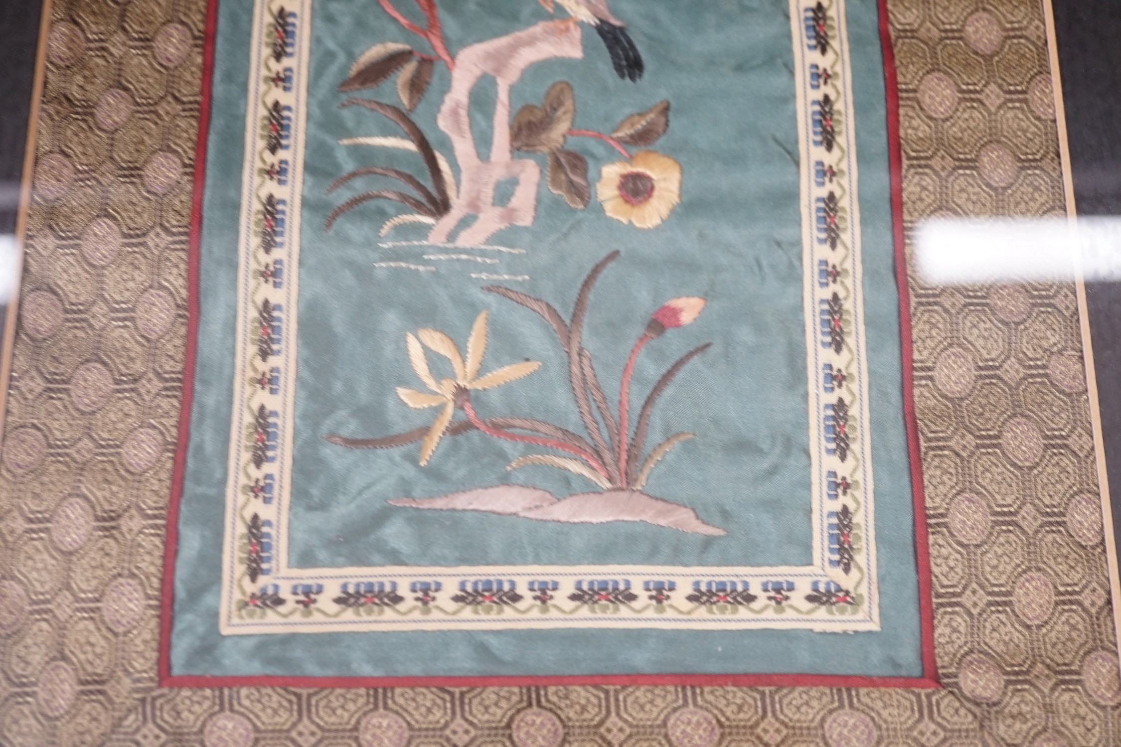 A pair of framed Chinese embroideries with bird and flower decoration, 34 x 14cm